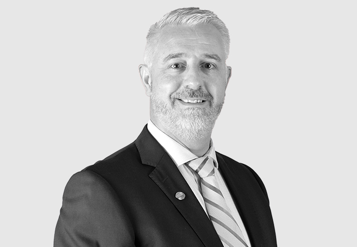 A headshot image of Iain Simpson